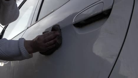 woman washing car with sponge side medium shot