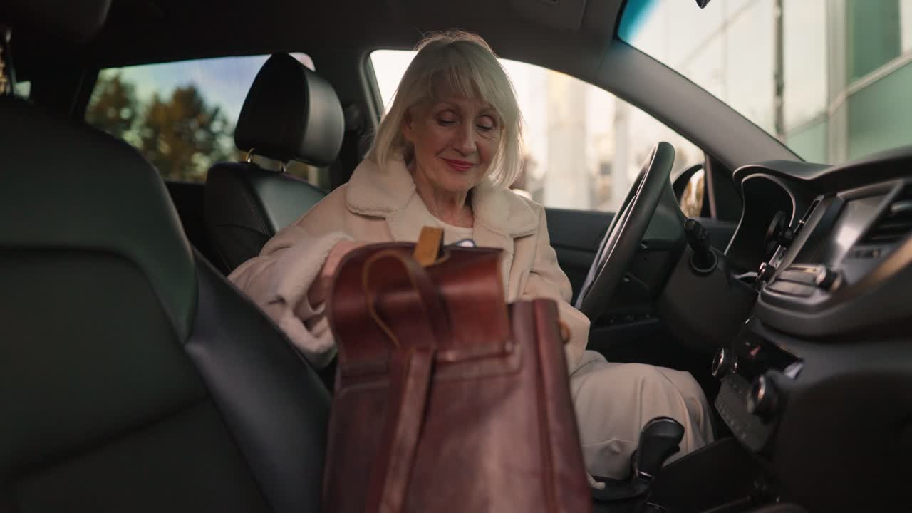 Senior Woman in Car with Purse