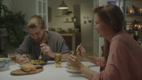 couple chatting over dinner at home