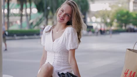 stylish woman sitting on the street