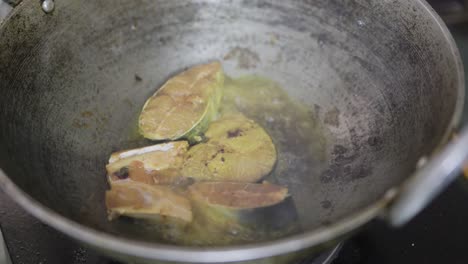 fresh fish frying at home in cauldron from different angle