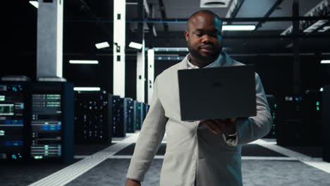 vertical video data center system administrator coding on laptop, doing software updates