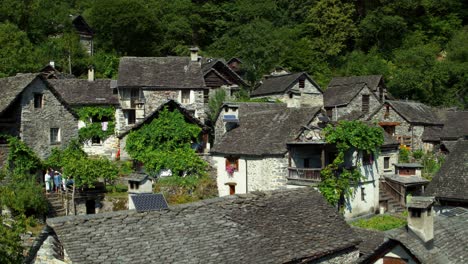 aerial drone flying up in the swiss village foroglio revealing more houses