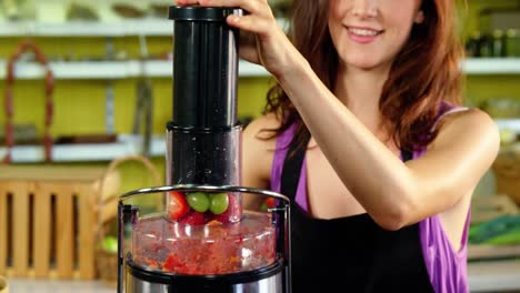 female staff preparing fresh juice in juicer