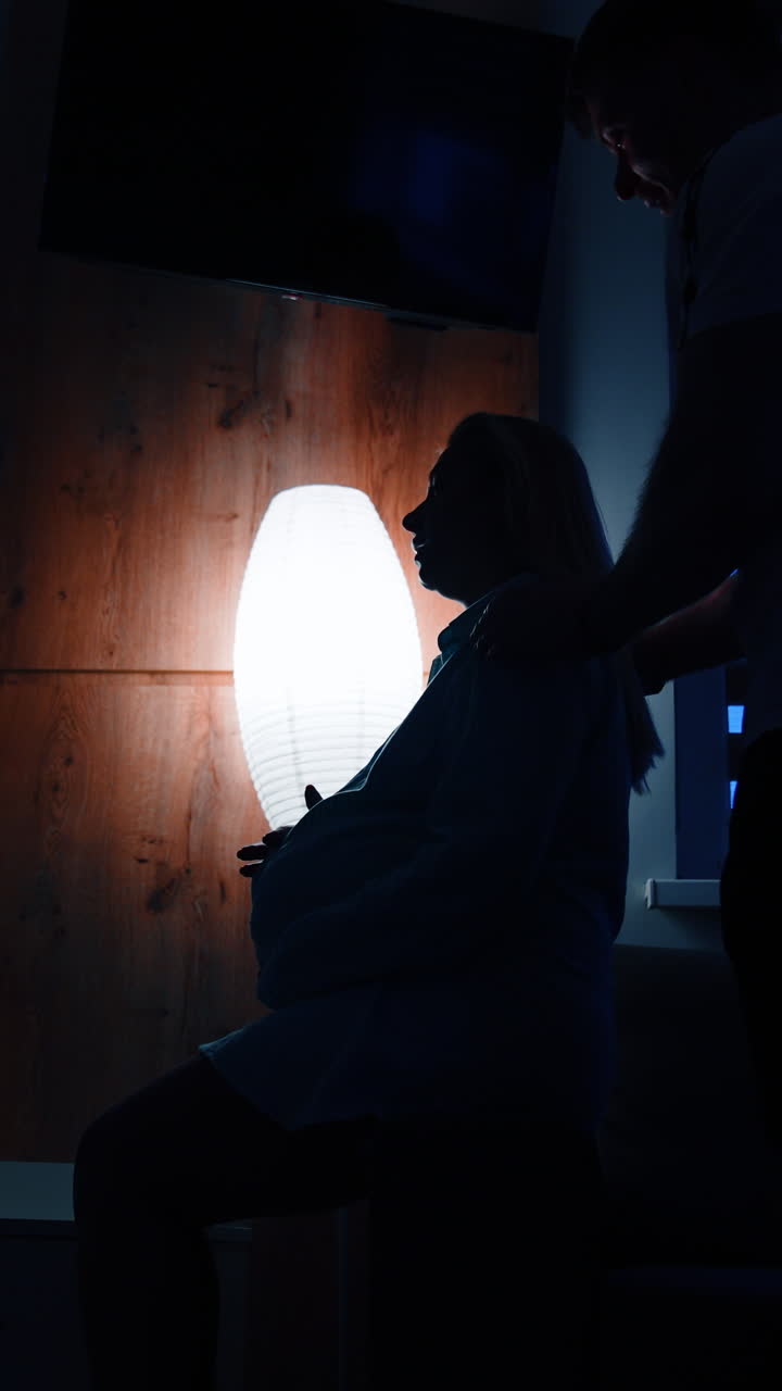 Pregnant Woman and Partner in Silhouette