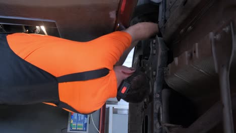 mechanic working underneath a car on a lift