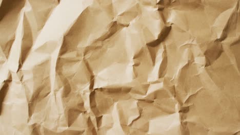 Video-of-close-up-of-crumpled-brown-paper-texture-background