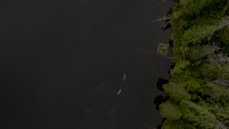 Top-down-of-two-Kayaks-paddling-on-flat-calm-lake