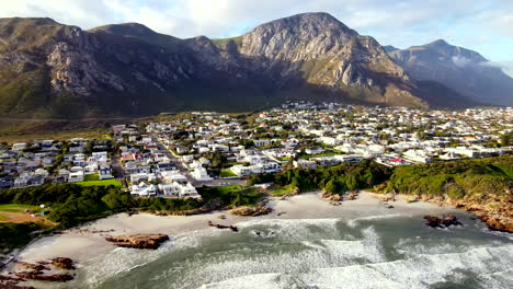 slow drone pan right reveals hermanus beaches and voëlklip under mountain