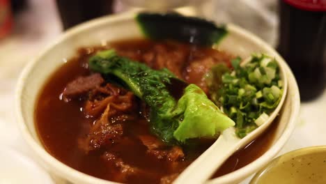 delicious noodle dish with meat and greens