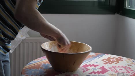 young man mixes ingredients while baking at home