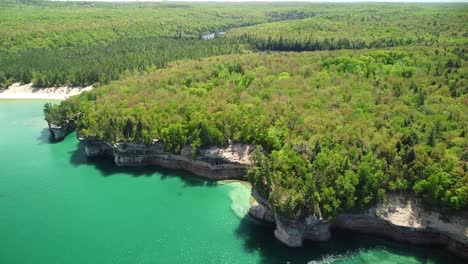 Sandstone-Rock-Cliff-Coast-Aerial-with-Beach,-Pictured-Rocks-National-Lakeshore