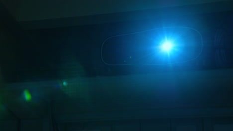 wide shot - a home cinema projector running, light beams, cinematic