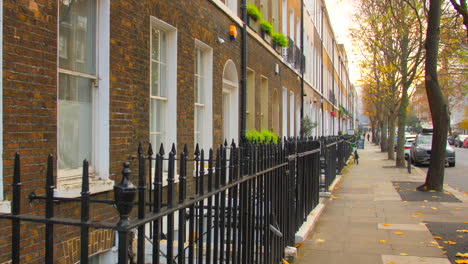 typical residential structures with black fences in the street of london, united kingdom