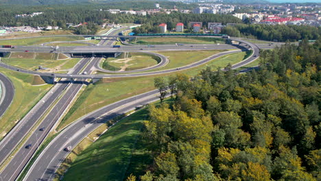 Aerial-circular-backward-view-of-cars-riding-surrounding-city-of-Gydnia