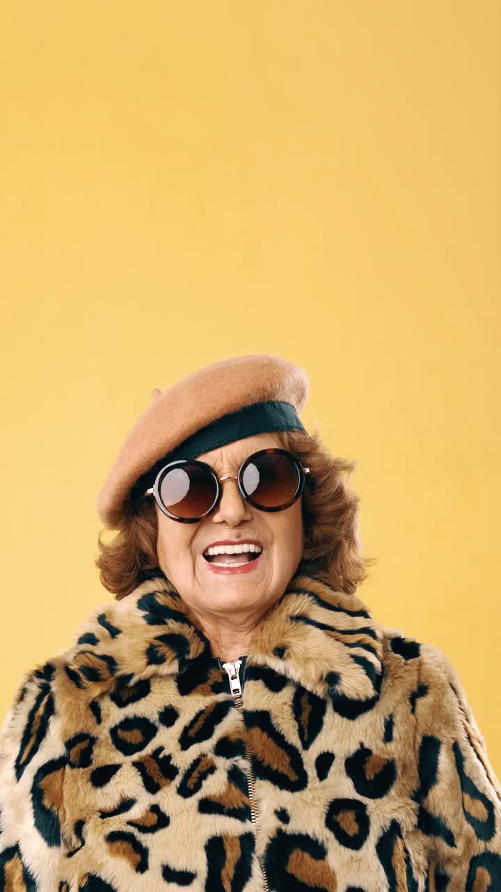 Stylish Elderly Woman in Leopard Print Coat and Sunglasses