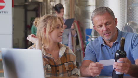 Workers-With-Laptop-Meeting-Checking-Production-Inside-Winery-With-Storage-Tanks