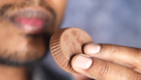 man holding a chocolate candy