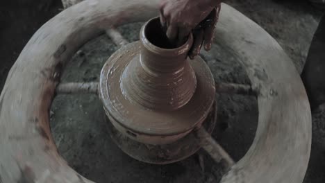 A-clay-pot-is-made-on-a-traditional,-hand-spun-potters-wheel