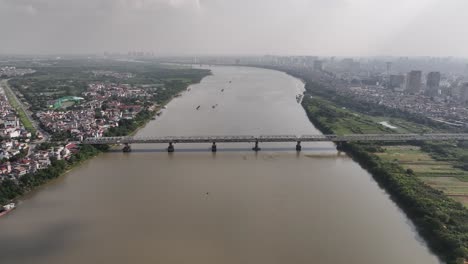 mist in distance, river water, cityscape of hanoi