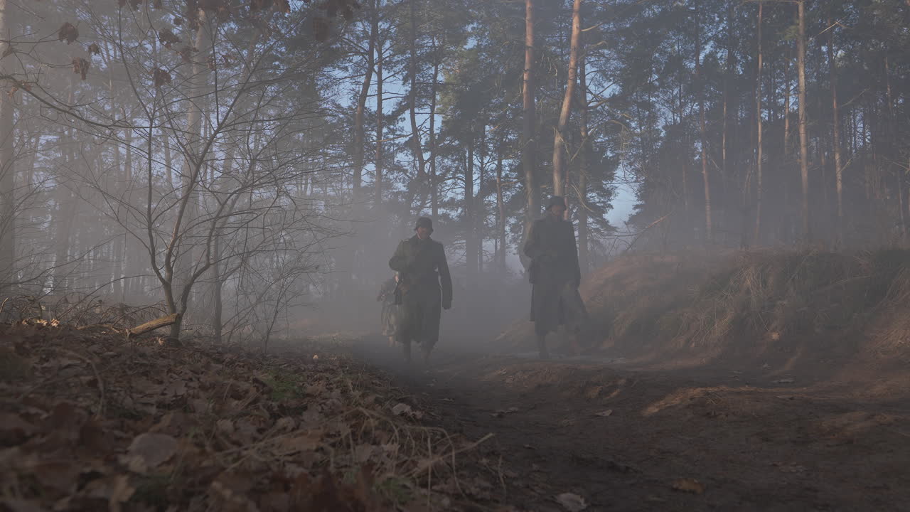 German soldiers marching through a foggy forest