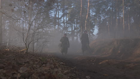 german soldiers marching through a foggy forest