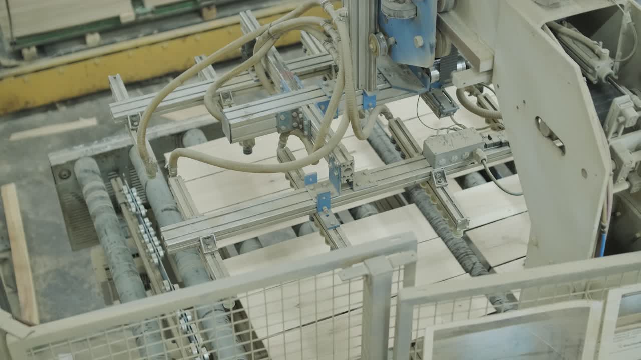 Automated Machine Stacking Wooden Planks in Industrial Factory