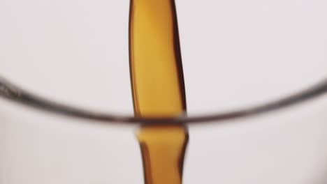 extreme close up of coffee getting poured into a glass