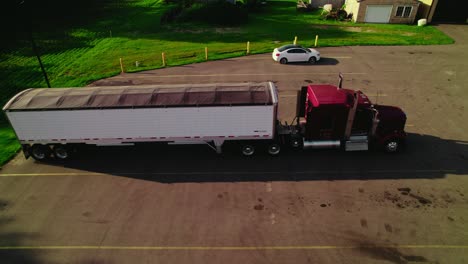 aerial view of a semi-truck and trailer parked in a rural area