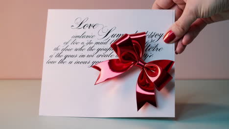 a love letter with a red bow