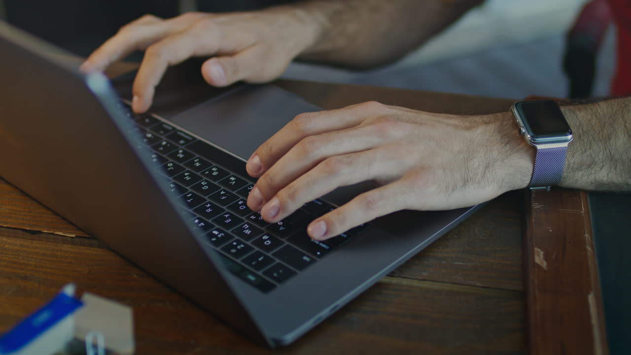Close up of male hands typing on keyboard. Typing hands on macbook keyboard