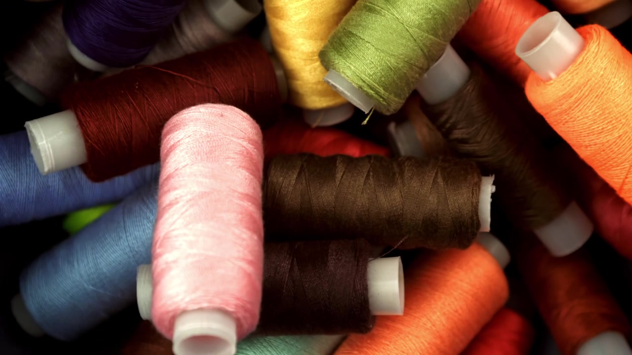 Close-up of Colorful Sewing Thread Spools with Focus Pull