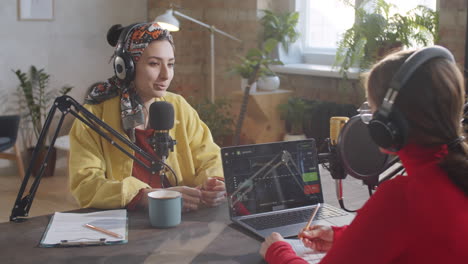 dos mujeres grabando podcast en el estudio