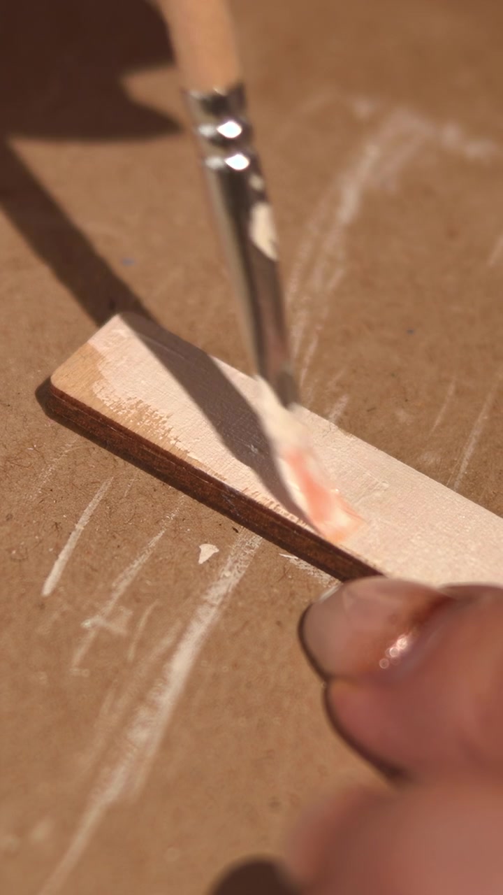 Closeup Detail Painting On Small Slat With Fine Tip Brush Adding White Coat Along Edge, Fingers Steady, Small