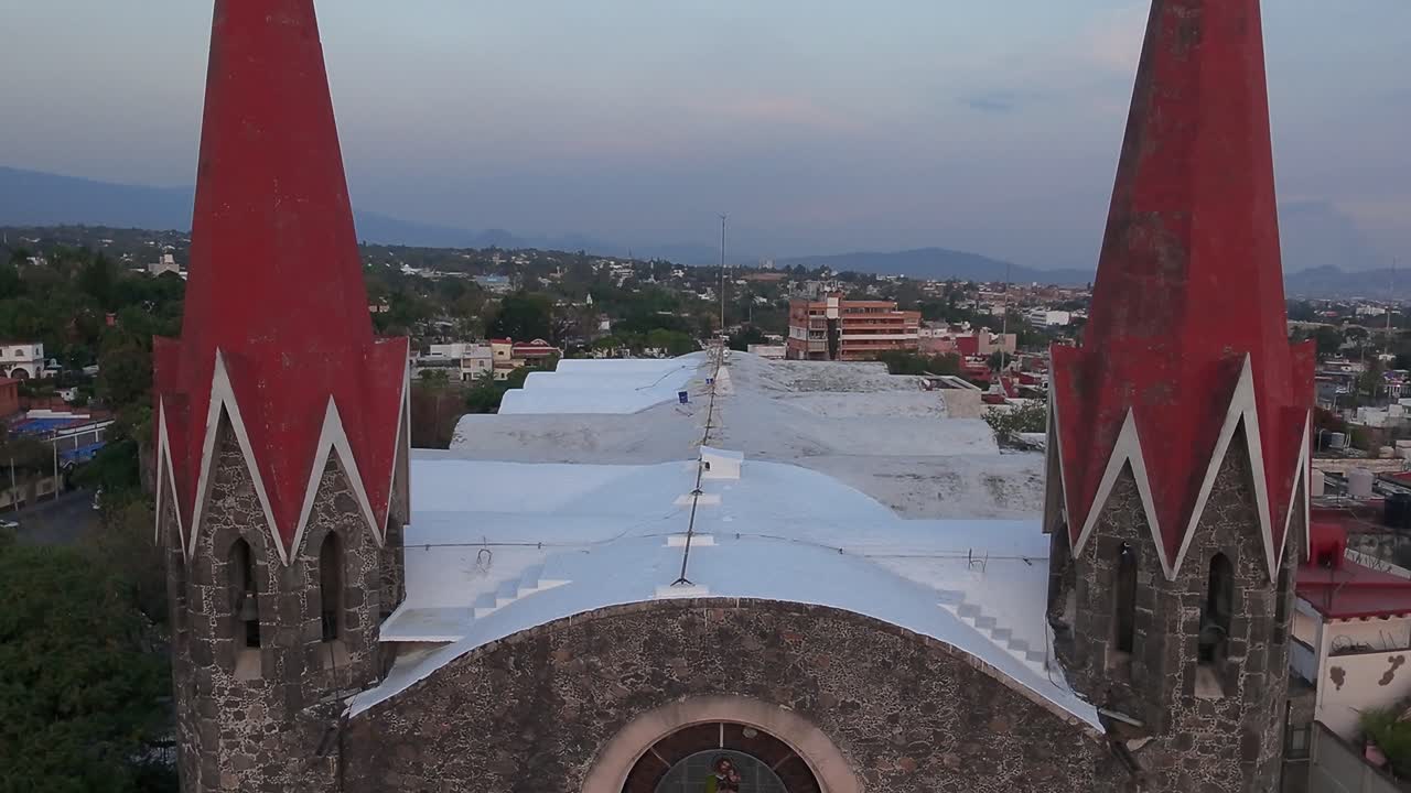 Crane down tilt up drone shot of Calvary's Church during the day in Cuernavaca, Morelos, Mexico