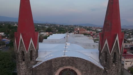 crane down tilt up drone shot of calvary's church during the day in cuernavaca, morelos, mexico