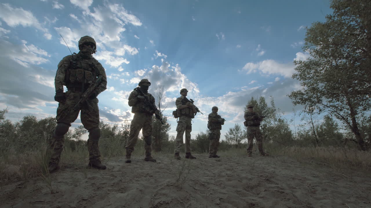 Military Personnel on a Hilltop