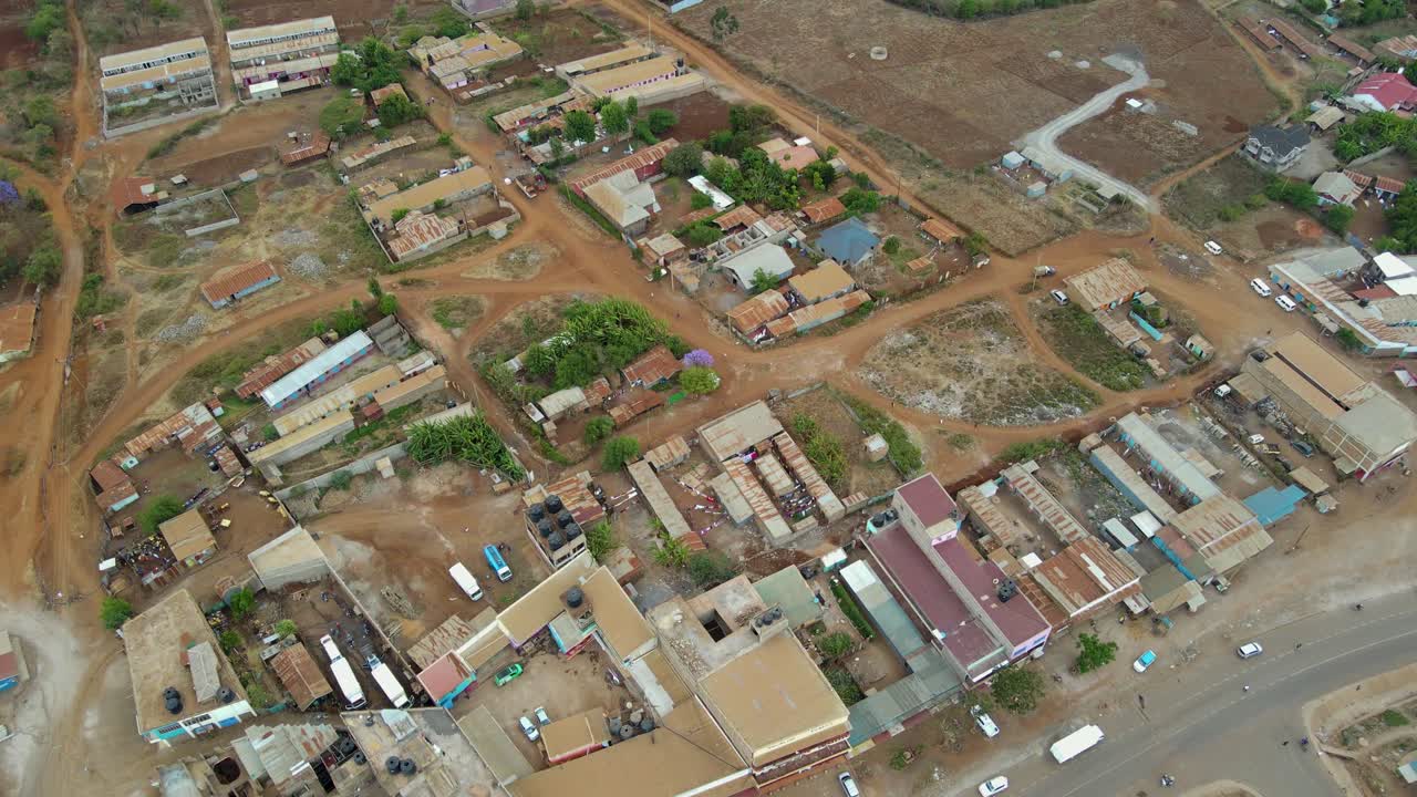 Vista aerea di una città e campi illuminati dal sole, ora d'oro nell'Africa rurale - ripresa in tracking con drone