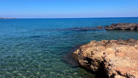 clear waters flowing over rocks at hersonissos village, crete island, greece