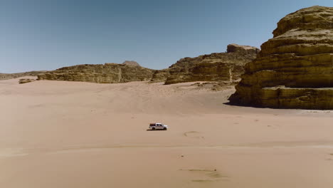 4x4 pick-up truck driving in the desert for sightseeing tour in wadi rum, jordan