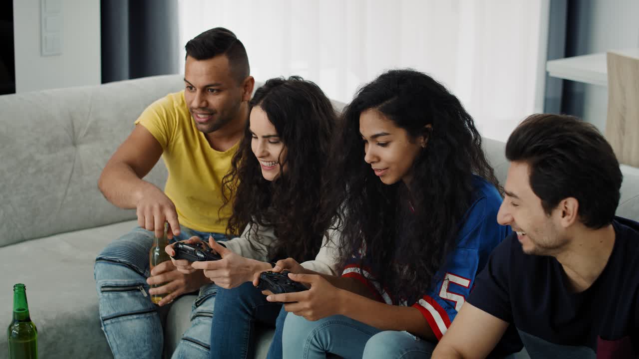Group of smiling friends playing on the game console