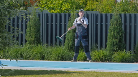 man cleaning pool