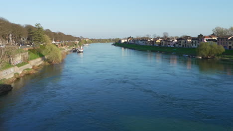 Panorama-of-Ticino-river-near-Pavia-and-moored-boat-at-sunny-day,-Lombardy,-italy