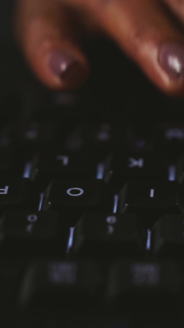 Close-up of Person Typing on Illuminated Computer Keyboard