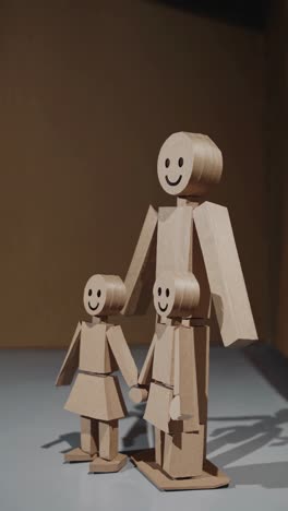 cardboard cutout figures representing a happy family, holding hands and smiling, symbolizing unity, love, and togetherness, perfect for family-oriented projects