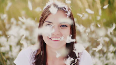 portrait of a young woman looks at the camera before her and on her down and down feathers