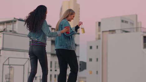 beautiful-young-woman-friends-walking-on-rooftop-edge-drinking-alcohol-enjoying-girls-night-out-in-city