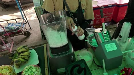 preparation of a coconut shake at a street stall