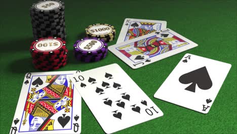 cards dealt onto a poker table with piles of gambling chips - poker hands - strong hand - royal flush in spades - ten, jack, queen, king, ace