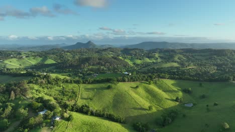 drone flying over hills near cooroy noosa, qld, with hilly terrain and the glass house mountains in the background